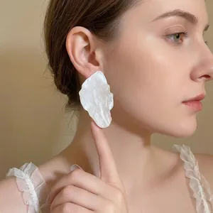 Elegant oversized pearl white leaf-shaped metal earrings with silver needle for women