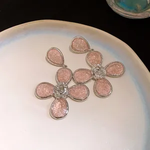 Detail view of an elegant resin flower necklace with teardrop drops and a silver finish.