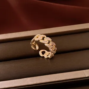 Detailed view of a 14k gold-plated Cuban link open ring with sparkling zirconia stones.