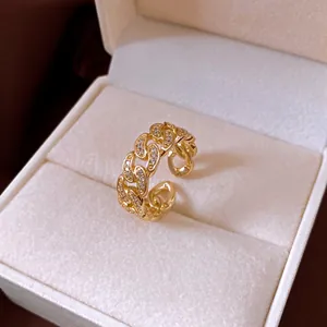 Detailed macro view of an elegant 14k gold plated chain link ring with sparkling zircons