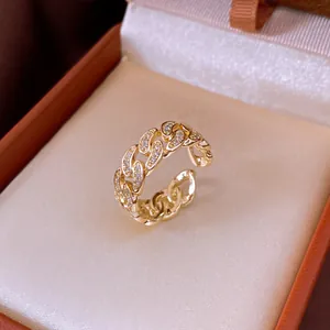 Detail shot of a 14k gold plated chain link ring with pavé zirconia stones