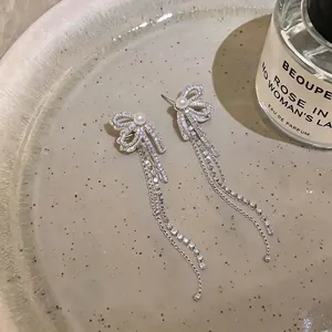 Elegant silver needle earrings featuring zircon pearls with bowknot and long tassel design