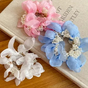 Close-up of chiffon flower scrunchies with elegant pearl bead clusters