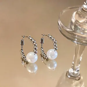 Elegant silver hoop earrings featuring metallic beads and a large lustrous white pearl