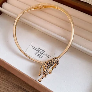 Detailed close-up of a luxury gold leopard choker necklace with black enamel spots