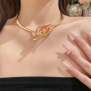 Statement gold choker necklace with red-spotted leopard pendant on female model