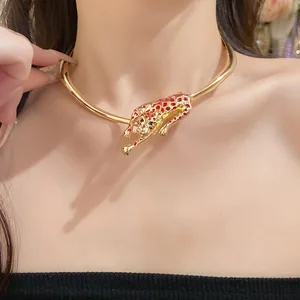 Close-up of a gold leopard pendant choker necklace with red spotted details on model.