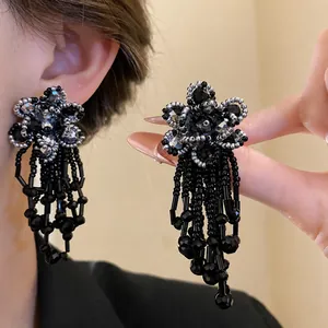 Elegant black and silver beaded flower tassel earrings with vintage aesthetic design.