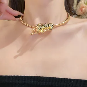 Close-up of a gold leopard choker necklace with black dripping oil panther pendant