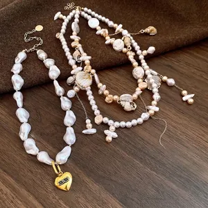 Bohemian pearl and shell layered necklace with golden heart pendant on wood