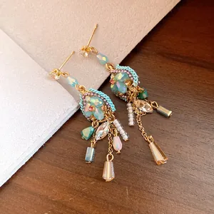 Detailed view of vintage-style drop earrings with colorful beads and gold-tone chains