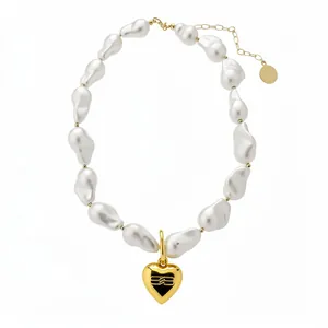 Elegant vintage baroque pearl necklace featuring a gold heart pendant and extension chain