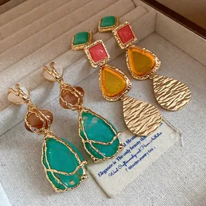 Elegant vintage resin teardrop drop earrings with golden frames displayed in a box