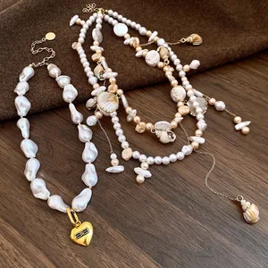 Detail view of vintage baroque pearl and seashell double-layer necklace with gold heart