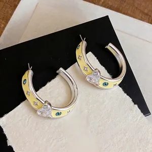 Elegant C-shaped earrings with yellow enamel heart zircon and star motifs