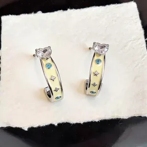 Elegant silver needle hoop earrings with heart zircon and evil eye enamel detail