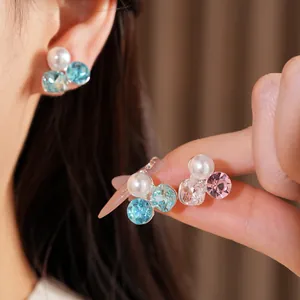 Close-up view of elegant crystal and faux pearl clip-on earrings designed for non-pierced ears
