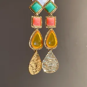 Detailed macro view of vintage resin drop earrings featuring geometric colorful beads