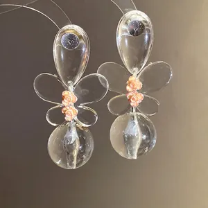 Elegant transparent butterfly earrings with delicate pink flower accents and sphere drops