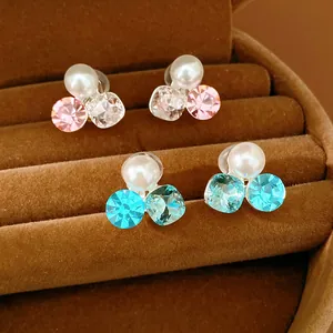 Elegant pearl and rhinestone clip-on earrings in pink and blue, displayed in a box.