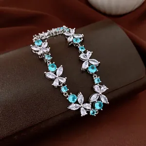 Elegant floral bracelet set with blue and clear cubic zirconia stones on leather