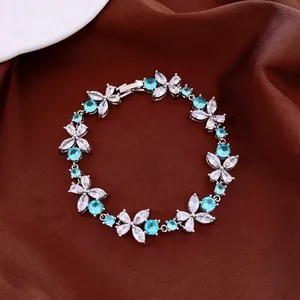 Detailed macro shot of flower bracelet featuring sparkling blue and white cubic zirconia.