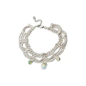 Elegant white glass beaded bracelet with iridescent crystal droplets and extension chain.