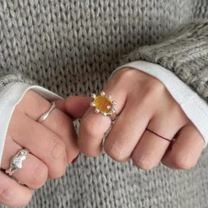 Close-up of 18k gold plated resin ring with beaded bezel on hand