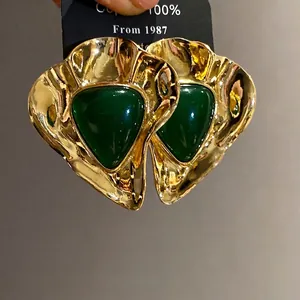 Vintage gold-tone resin triangle earrings with emerald green center in retro court style