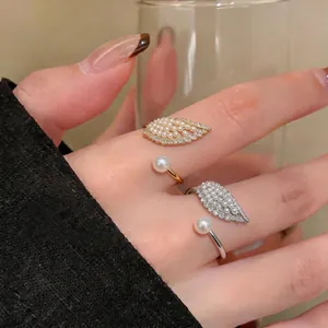 Elegant wing-shaped adjustable open rings with pearls and zircons in gold and silver