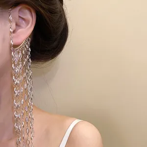 Detail of elegant silver tassel ear cuff with sparkling marquise zircons