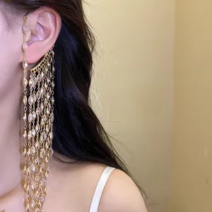 Close-up detail of luxury gold zircon tassel ear cuff with marquise-cut stones