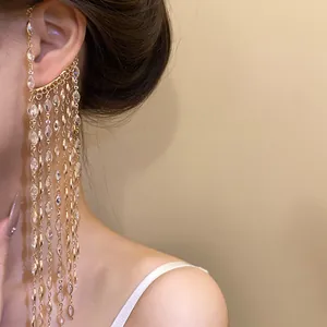 Close-up of elegant gold tassel ear cuff adorned with marquise-cut sparkling zircons