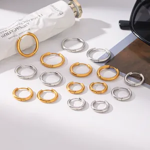 Detailed view showing various sizes of minimalist titanium steel hoop earrings in gold and silver