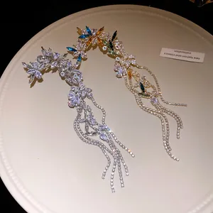 Luxurious cubic zirconia flower ear cuffs with shimmering long tassels in silver and gold.