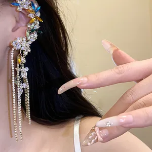 Close-up detail of a colorful zircon flower ear cuff with elegant long crystal tassels