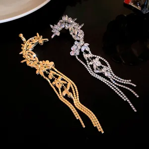 Close-up of gold and silver flower tassel ear cuffs with sparkling cubic zirconia