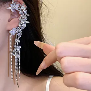 Macro view of exquisite rhinestone zircon flower ear cuff with sparkling long tassels