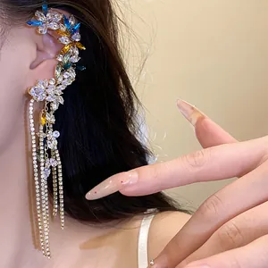 Detailed view of an elegant floral tassel ear cuff with sparkling cubic zirconia on model ear
