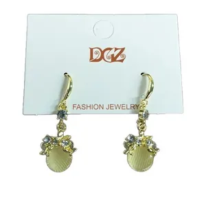 Elegant gold-tone hook earrings with round pale yellow resin beads and sparkling crystals