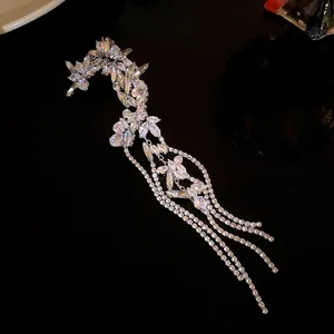 Detailed view of sparkling silver zircon flower ear cuff with long elegant tassels