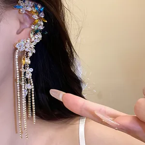 Close-up detail of a floral ear cuff with colorful zircons and long crystal tassels.