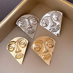 Vintage abstract face portrait stud earrings in gold and silver metallic finish