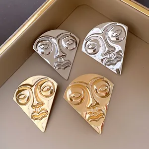 Abstract face-shaped fan earrings in polished gold and silver metallic finish for women