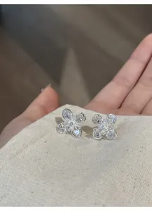 Close-up of elegant clear zircon flower stud earrings with shimmering silver petals
