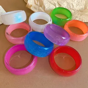 Collection of colorful irregular geometric resin bangles with a sparkling glitter finish