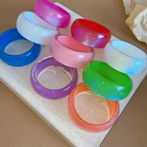 Collection of vibrant colorful chunky resin geometric bangles with glitter shimmer finish