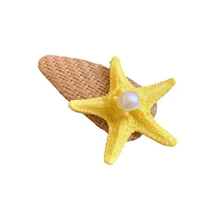 Elegant handmade raffia starfish hair clip with pearl detail for summer beach vacation