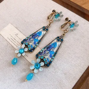 Vintage court style floral resin drop clip-on earrings with blue rhinestones and beads
