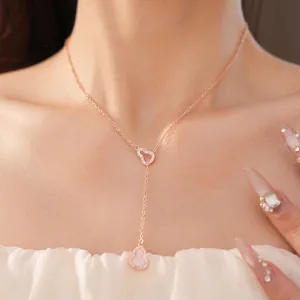 Elegant rose gold necklace featuring a pink zircon calabash pendant worn by an Asian model